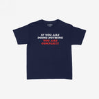 Navy-blue Don't Be Complicit Baby Tee featuring a bold slogan in white and red, embodying a protest message. The tee offers a retro cut for versatile styling options.