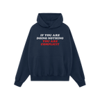 Dark-navy Don't Be Complicit Hoodie with bold slogan IF YOU ARE DOING NOTHING YOU ARE COMPLICIT across the chest, featuring a