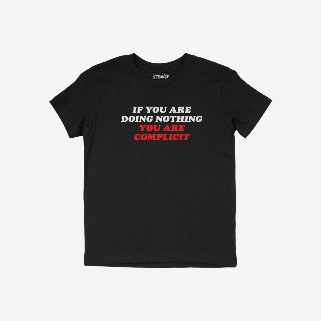 Don't Be Complicit T-shirt featuring bold, white and red slogan against injustice. The short-sleeve, black tee embodies activism with its compelling message, designed for those who advocate equality and human rights.