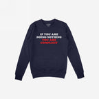Don't Be Complicit sweatshirt in navy blue with bold slogan, ribbed cuffs, and hem. Perfect for showcasing your values in everyday life or protests. Features IF YOU ARE DOING NOTHING, YOU ARE COMPLICIT.