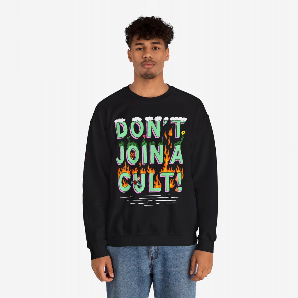 Young man in a black Don't Join A Cult sweatshirt with cartoonish lettering and doodles, conveying a bold, progressive message. Perfect for expressing individuality and supporting causes.