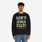 Young man in a black Don't Join A Cult sweatshirt with cartoonish lettering and doodles, conveying a bold, progressive message. Perfect for expressing individuality and supporting causes.