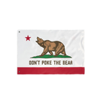 California Don't Poke The Bear Flag features a grizzly on green grass with a red star, bold text, and stripe, symbolizing def