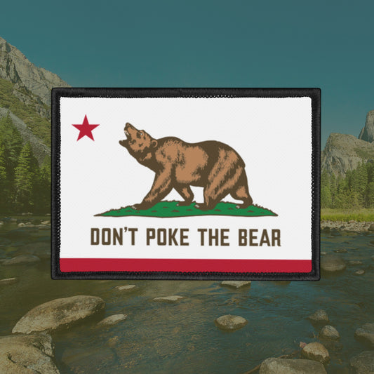California Don't Poke The Bear Flag Patch features a bear on a grassy mound with a bold message, outlined in black stitching, symbolizing resistance against oppression.