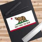 Don’t Poke The Bear sticker placed on a desk surface, California political decor for workspaces or organizing hubs
