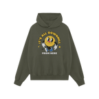 Green pullover hoodie featuring the Downhill Shirt design: a playful yellow smiley-face cartoon with IT’S ALL DOWNHILL and 