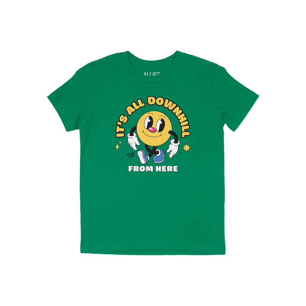 Downhill Shirt features a cheerful vintage-cartoon smiley with “IT’S ALL DOWNHILL FROM HERE” text, embodying a playful