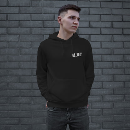 Young man in a black Dreams hoodie with ALLIES logo, embodying ambition and resilience. The hoodie features a front pouch pocket, reflecting defiance and determination. Perfect for those courageously chasing dreams.