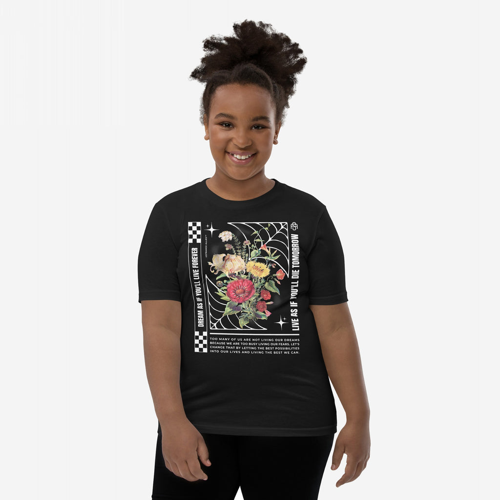 Young girl wearing the Dreams T-shirt featuring floral graphics with motivational slogans, a wearable manifesto for overthinkers, promoting a life full of dreams and urgency.