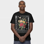 Man wearing the Dreams T-shirt, featuring vibrant flowers in a spider-web frame with inspiring text: “Dream as if you’ll live forever, live as if you’ll die tomorrow.” Hands clasped, conveying hope.