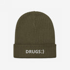 Olive-green rib-knit beanie with DRUGS;) embroidered in white on the cuff, capturing the bold, ironic statement of the Drugs Hat. Perfect for casual, edgy, and conversation-starting looks.