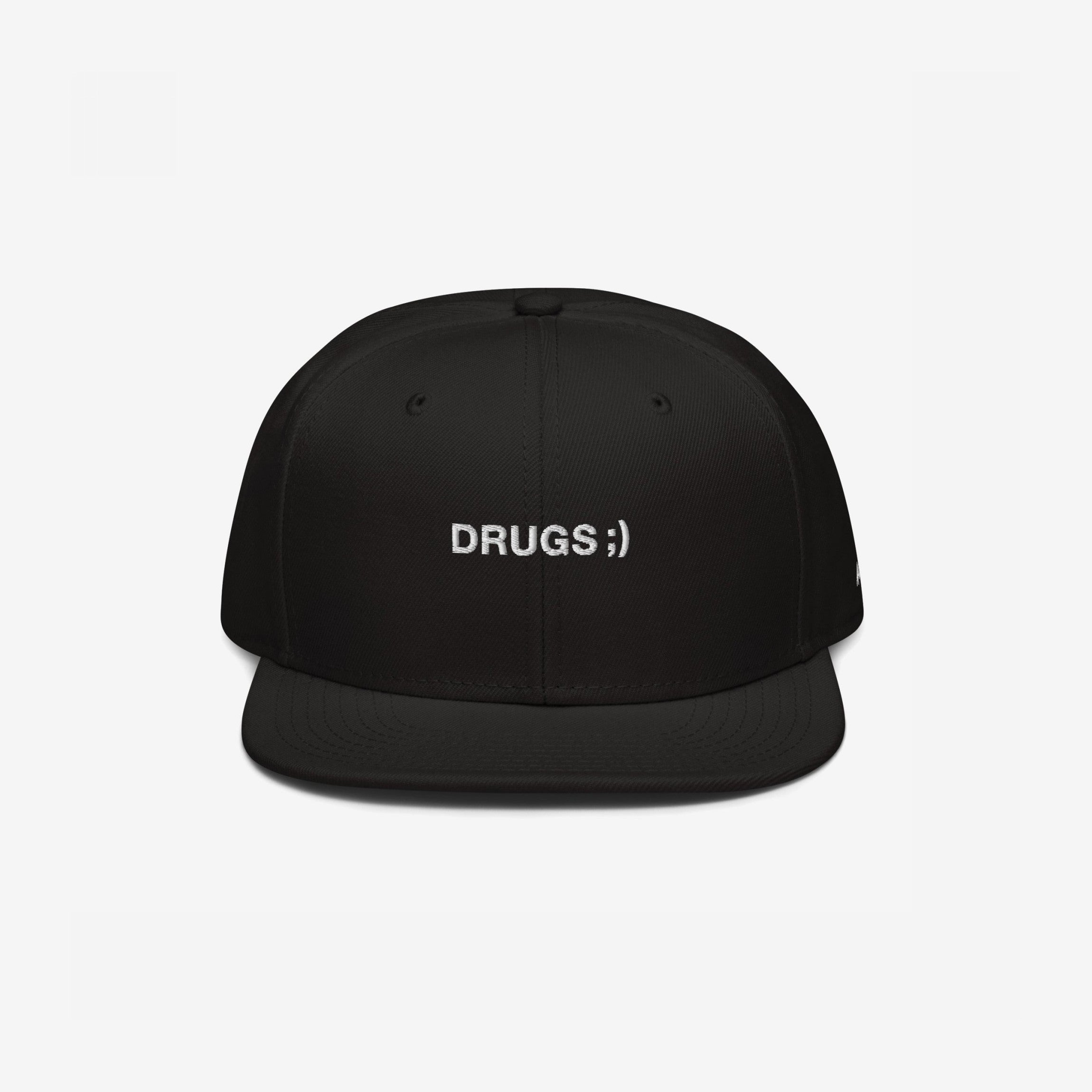 Black flat-brim snapback cap with DRUGS ;) embroidered in white, offering bold, edgy style. Ideal for making a statement, this hat aligns with the store's ethos of supporting equality and diversity.