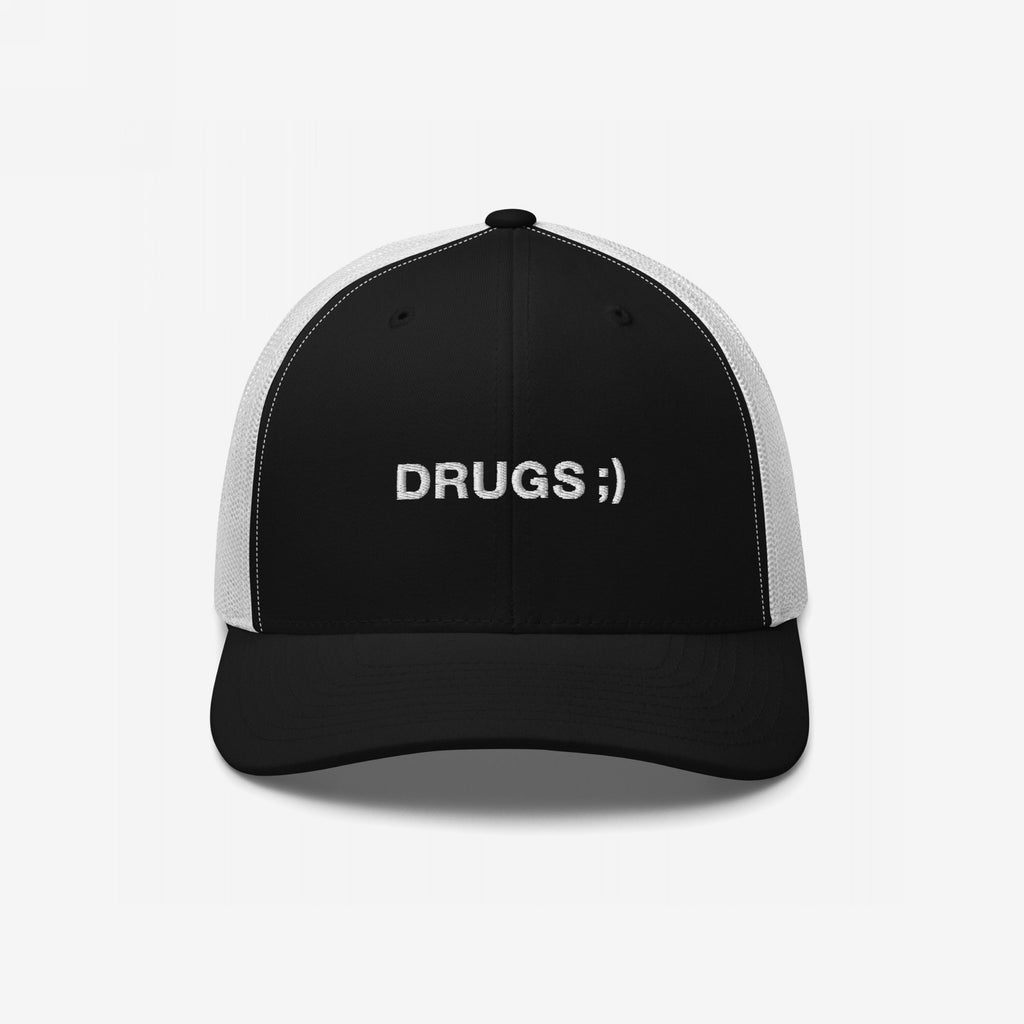 Drugs Hat: A black trucker cap with white mesh back, featuring DRUGS ;) embroidered in white sans-serif font, blending minimalist style with bold, ironic messaging.