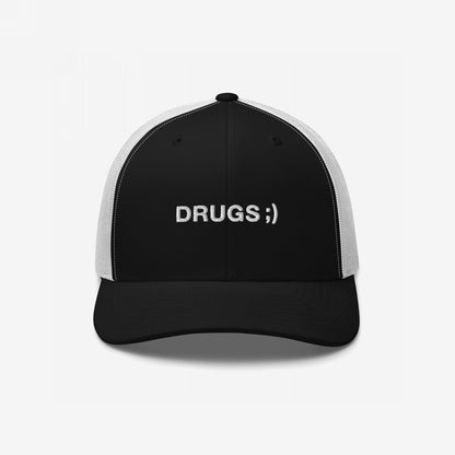 Drugs Hat: A black trucker cap with white mesh back, featuring DRUGS ;) embroidered in white sans-serif font, blending minimalist style with bold, ironic messaging.