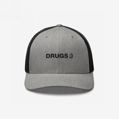 Gray-and-black trucker cap with DRUGS ;) embroidered on the front, making a bold, ironic statement. This hat adds edgy humor to any outfit, embodying a rebellious, conversation-starting style.