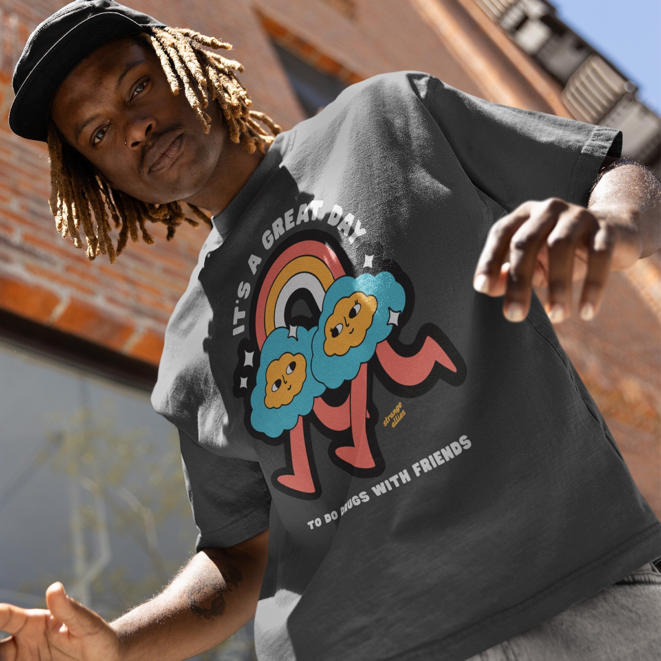 Young person wearing Drugs With Friends T-shirt, featuring cartoon-style design with playful text promoting connection and community. A reflection of individuality and nonconformity from a socially conscious store.
