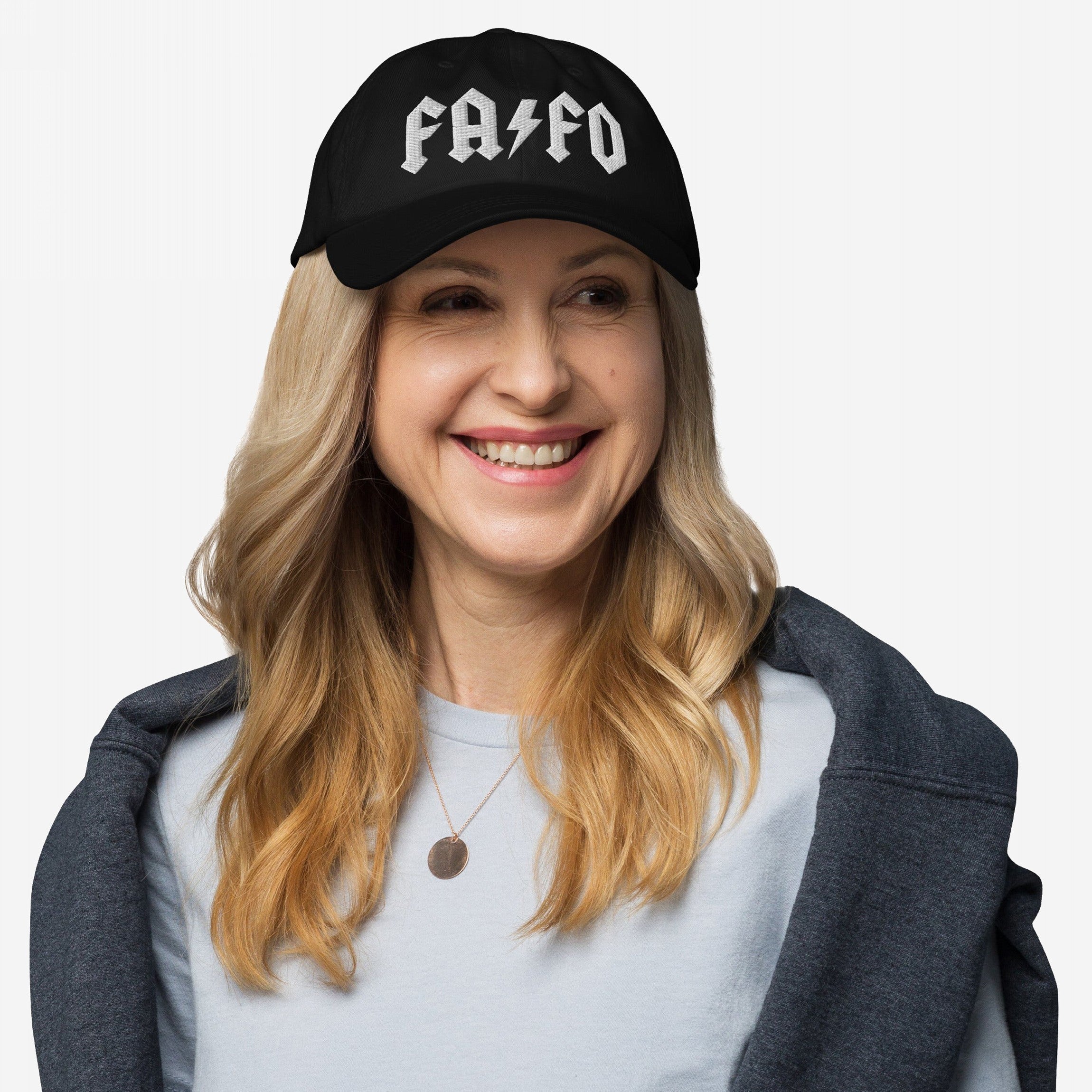 Woman wearing FAFO Hat with bold white lettering, embodying resistance against extremism. The cap's hard rock-inspired style complements her casual attire, emphasizing a strong, minimalist political statement.