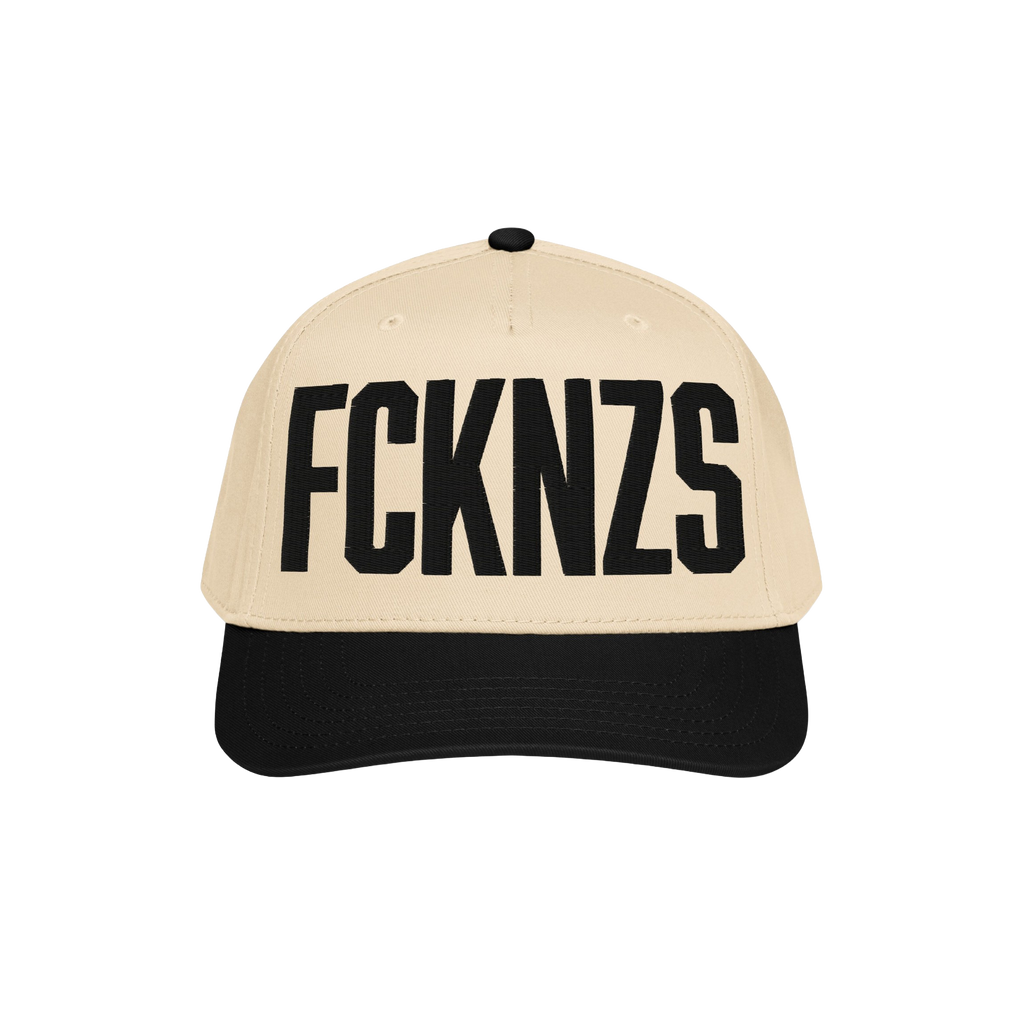 Two-tone FCKNZS Hat with beige crown and black brim, featuring bold black letters FCKN7S on the front, embodying a strong ant