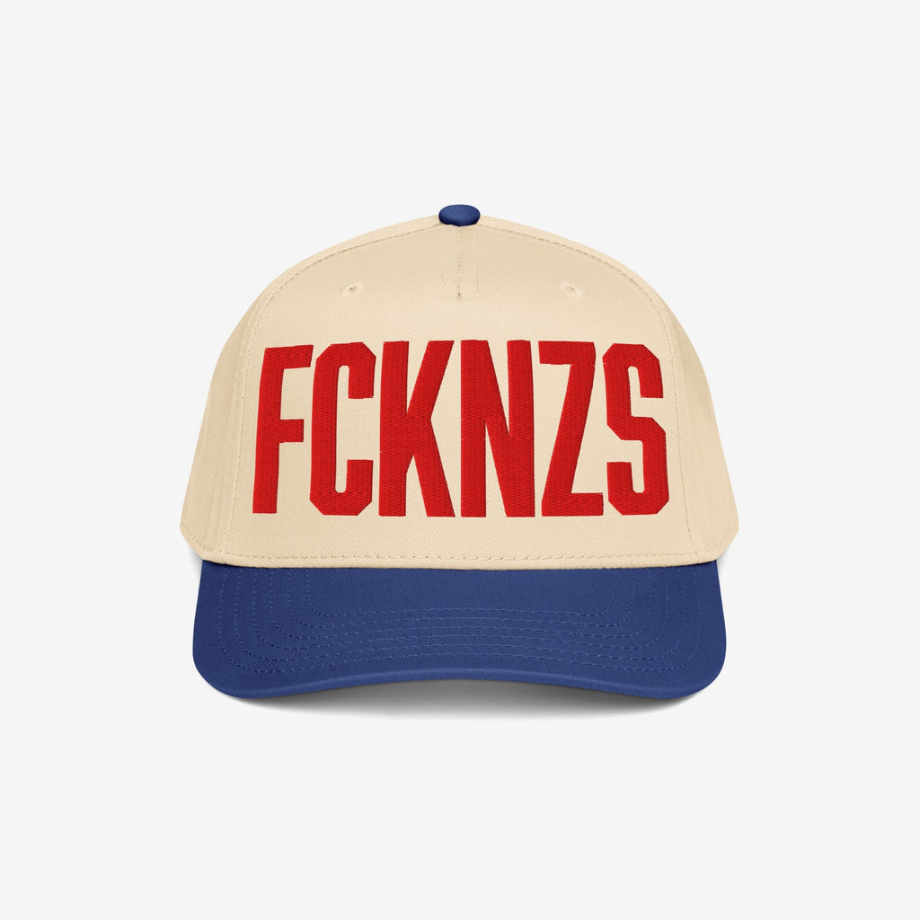 FCKNZS Hat: A two-tone baseball cap with a beige front and royal-blue brim, featuring bold red embroidered FCKNZS, symbolizing anti-fascism and equality. Perfect for marches and everyday statements.