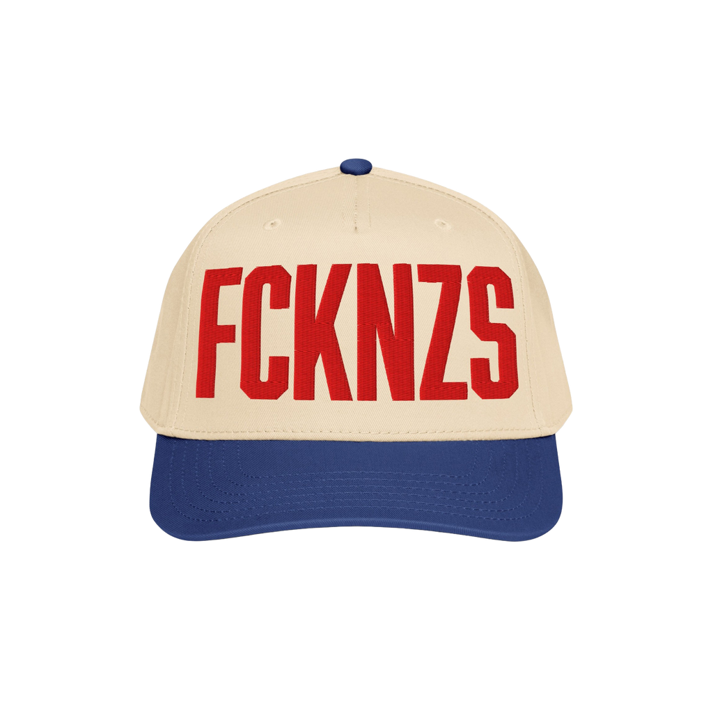 FCKNZS Hat: A two-tone baseball cap with a beige front and royal-blue brim, featuring bold red embroidered FCKNZS, symbolizin