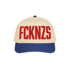 FCKNZS Hat: A two-tone baseball cap with a beige front and royal-blue brim, featuring bold red embroidered FCKNZS, symbolizin