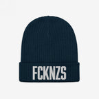 Navy-blue ribbed knit beanie with FCKNZS embroidered in bold white letters, representing an anti-fascist stance.