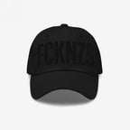 FCKNZS Hat: A black six-panel baseball cap with FCKNZS embroidered in black, symbolizing anti-fascist protest. Features a curved bill and ventilation eyelets, embodying a bold stance against hate.