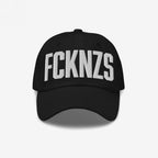 Black FCKNZS Hat with bold white embroidered letters, conveying an anti-fascist message. Perfect for making a statement at marches or in everyday life.