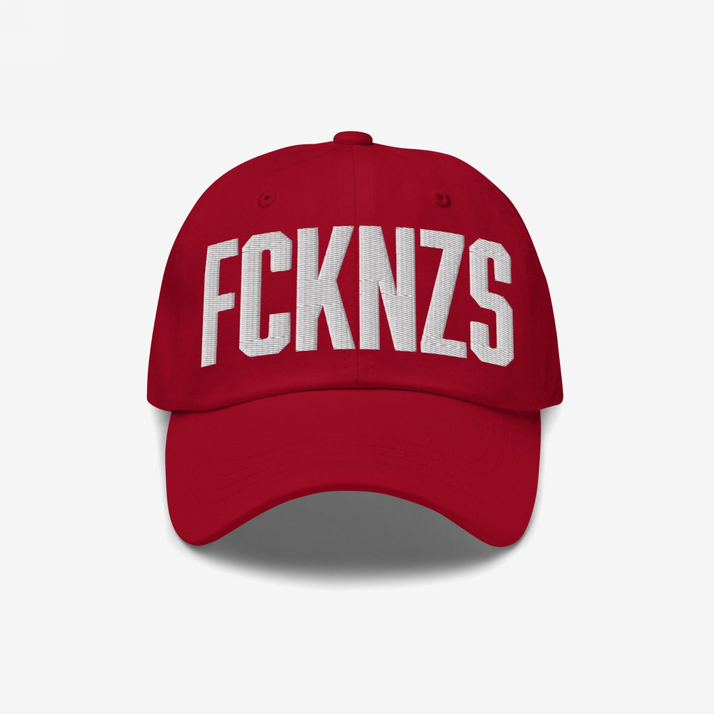 Red FCKNZS Hat with FCKNZS embroidered in white on the front, symbolizing anti-fascist protest. Ideal for those wanting a visible stance against hate, crafted for everyday activism.