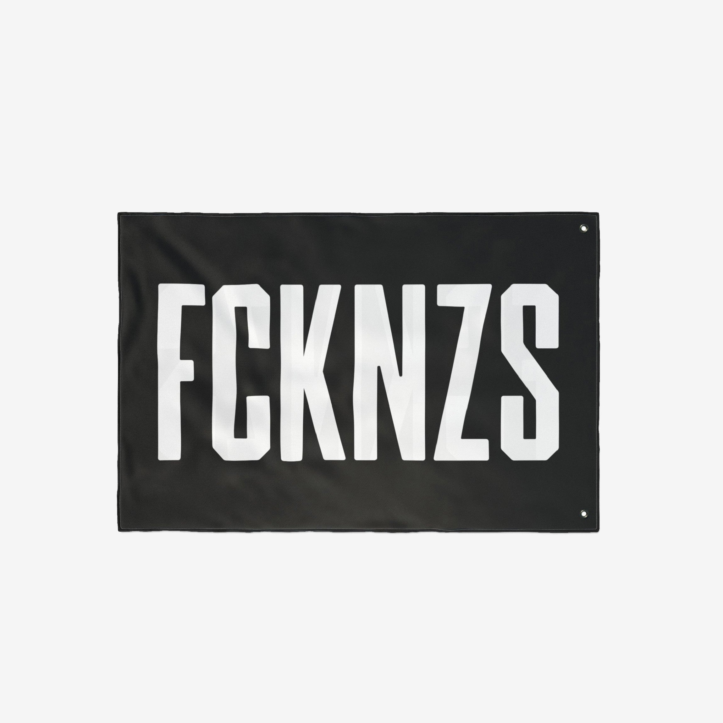 FCKNZS Flag with bold white text on a black background, featuring metal grommets for easy hanging. Designed for anti-fascist expression, suitable for home display or protests.