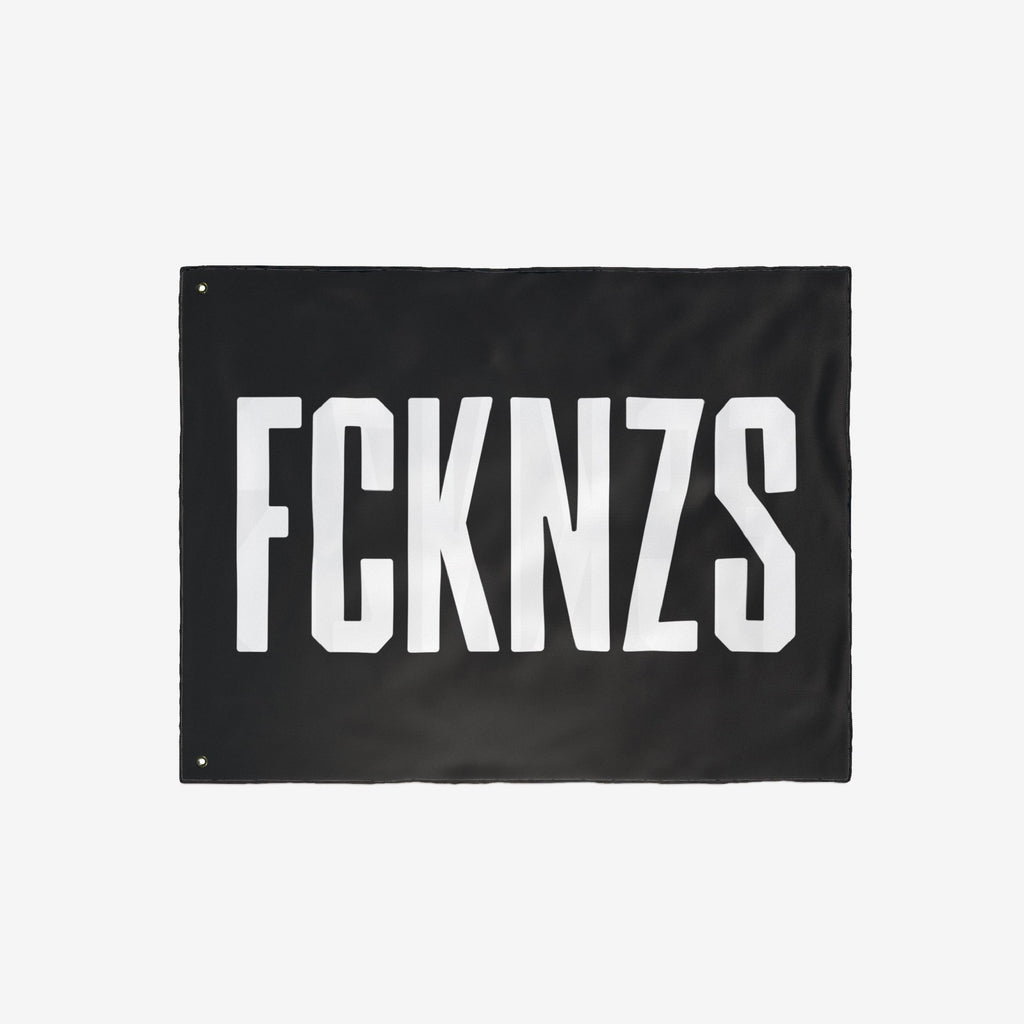 FCKNZS Flag: A black banner with bold white letters FCKNZS, featuring metal grommets, designed for anti-fascist expression. Ideal for displaying firm boundaries against hate, available in various sizes.