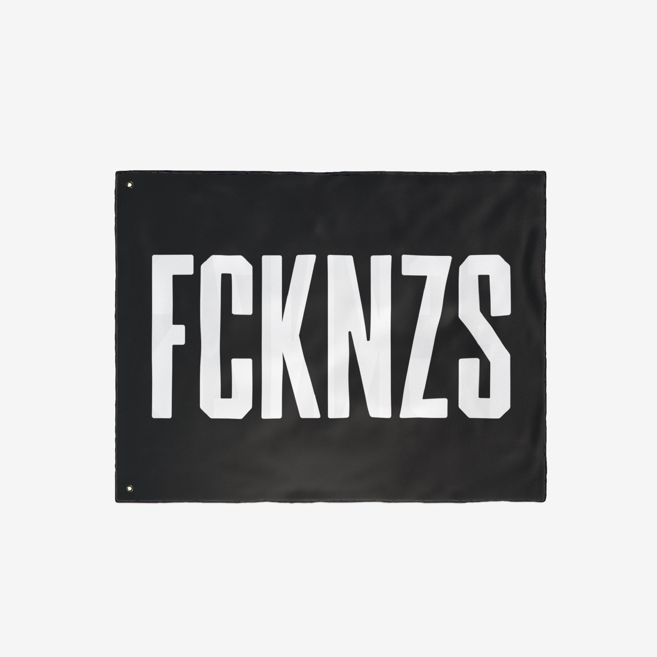 FCKNZS Flag: A black banner with bold white letters FCKNZS, featuring metal grommets, designed for anti-fascist expression. Ideal for displaying firm boundaries against hate, available in various sizes.