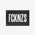 FCKNZS Flag with bold white text on black fabric, featuring metal grommets for easy hanging. Ideal for anti-fascist statements at home or events, available in multiple sizes for impactful visibility.