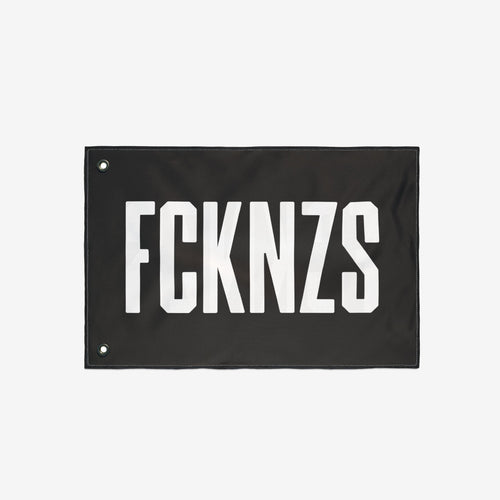 FCKNZS Flag with bold white text on black fabric, featuring metal grommets for easy hanging. Ideal for anti-fascist statements at home or events, available in multiple sizes for impactful visibility.