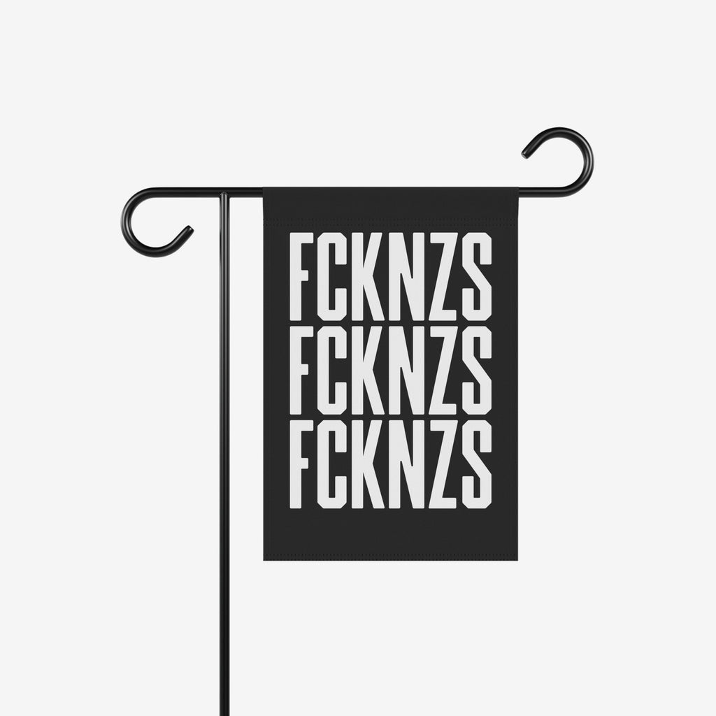 FCKNZS Garden Flag displayed on a black metal stand, featuring bold white letters on a black background. Sized 12 x 18, it boldly conveys an anti-fascist message for outdoor display.