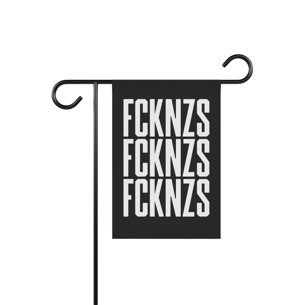 FCKNZS Garden Flag displayed on a black metal stand, featuring bold white letters on a black background. Sized 12 x 18, it bo