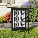 The FCKNZS Garden Flag features bold white text on a black background. Displayed on a metal stake, it boldly conveys an anti-fascist message in a neatly kept front yard.