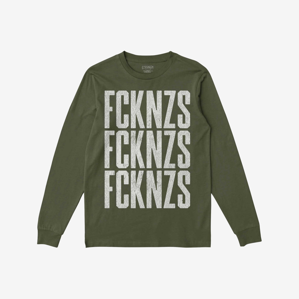 Olive-green FCKNZS T-shirt with distressed white block letters stacked vertically, embodying an anti-fascist message. Long-sleeve design laid flat, showcasing bold protest statement against hate.