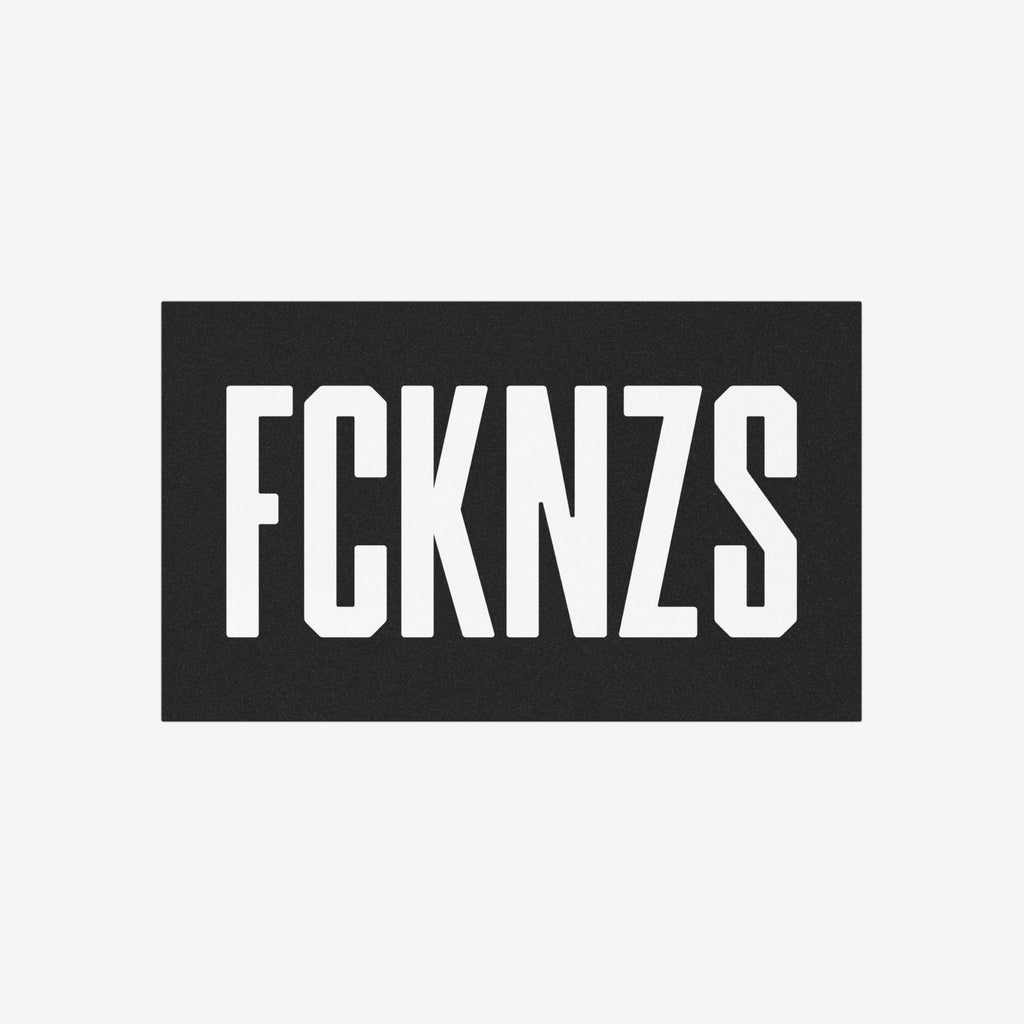 FCKNZS Sticker & Magnet featuring bold, white block letters on a black panel, designed for anti-fascist protests. Available as a 7.5 x 3.75-inch sticker or 7.5 x 4.5-inch magnet.