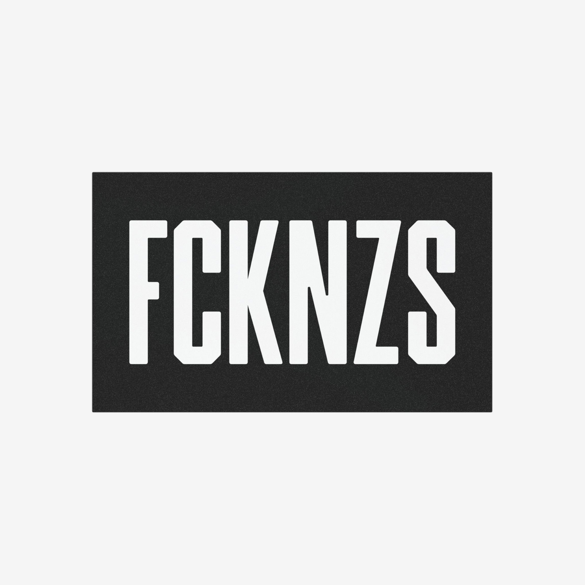 FCKNZS Sticker & Magnet featuring bold, white block letters on a black panel, designed for anti-fascist protests. Available as a 7.5 x 3.75-inch sticker or 7.5 x 4.5-inch magnet.