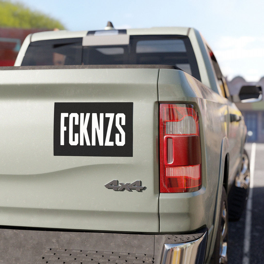 FCKNZS Sticker & Magnet on a light-colored pickup truck tailgate, featuring bold white letters on black, embodying anti-fascist sentiment for visibility and recognition, with options in sticker or magnet form.