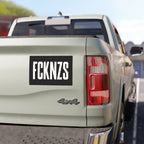 FCKNZS Sticker & Magnet on a light-colored pickup truck tailgate, featuring bold white letters on black, embodying anti-fascist sentiment for visibility and recognition, with options in sticker or magnet form.
