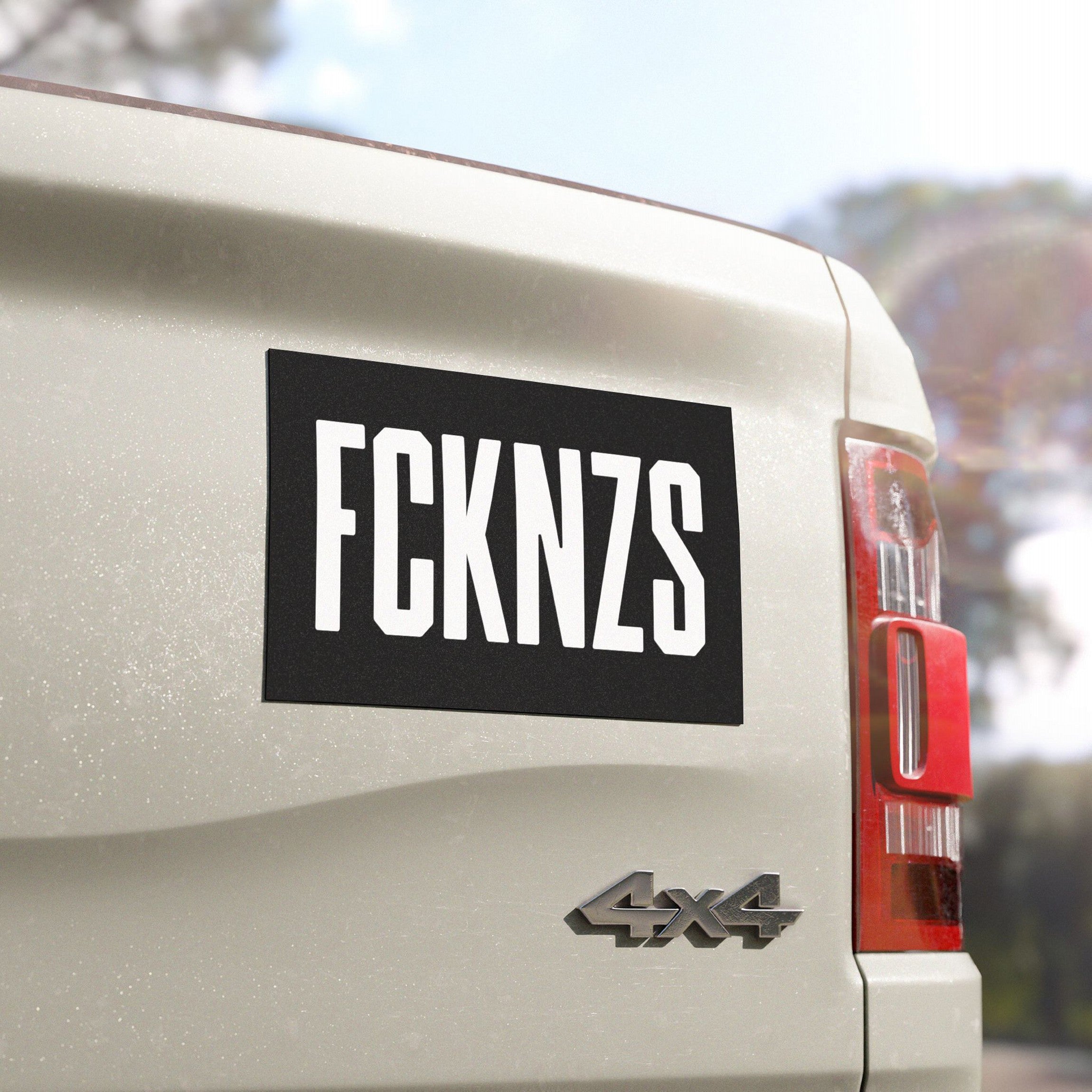 FCKNZS Sticker & Magnet displayed on a 4x4 vehicle's tailgate, featuring a bold FCKNZS message in black-and-white, signifying anti-fascist protest. Ideal for visible, impactful statements against hate.