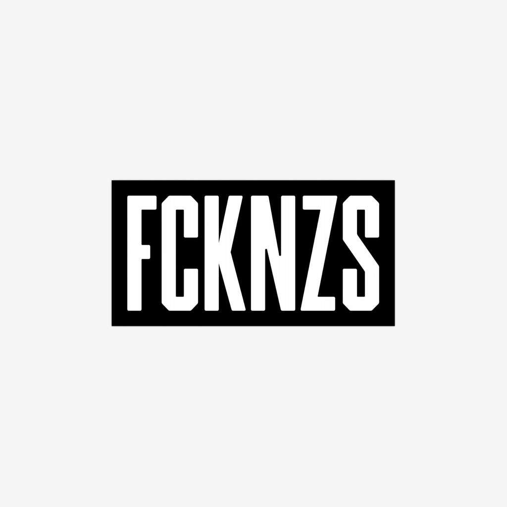 FCKNZS Sticker & Magnet featuring bold stencil-style FCKNZS text in white on black, symbolizes anti-fascist protest. Available as 7.5 x 3.75 sticker or 7.5 x 4.5 magnet.