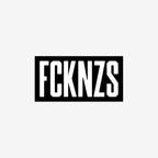FCKNZS Sticker & Magnet featuring bold stencil-style FCKNZS text in white on black, symbolizes anti-fascist protest. Available as 7.5 x 3.75 sticker or 7.5 x 4.5 magnet.