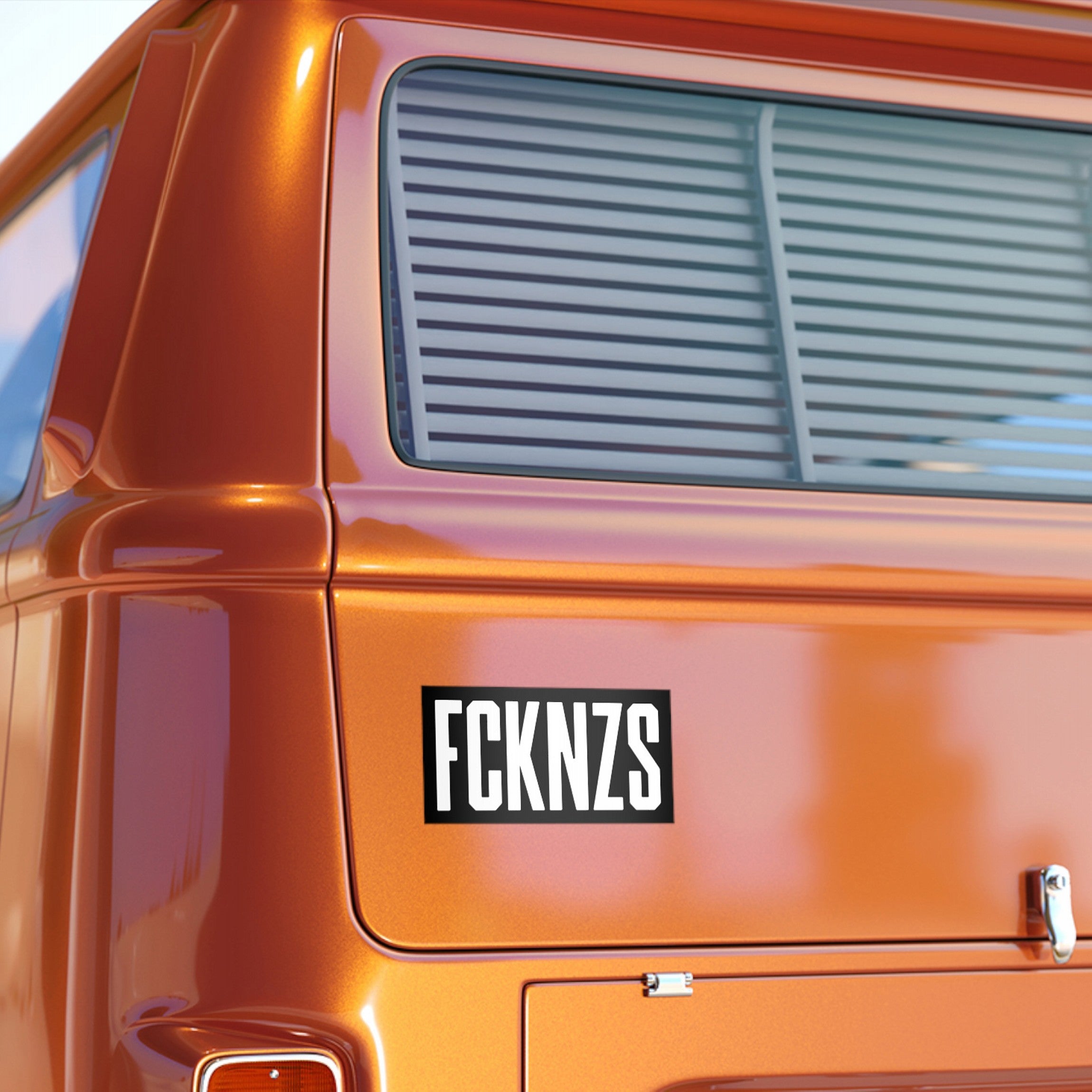 FCKNZS Sticker & Magnet displayed on the rear corner of a metallic van, emphasizing anti-fascist sentiment with bold lettering, ideal for promoting equality and standing against hate.