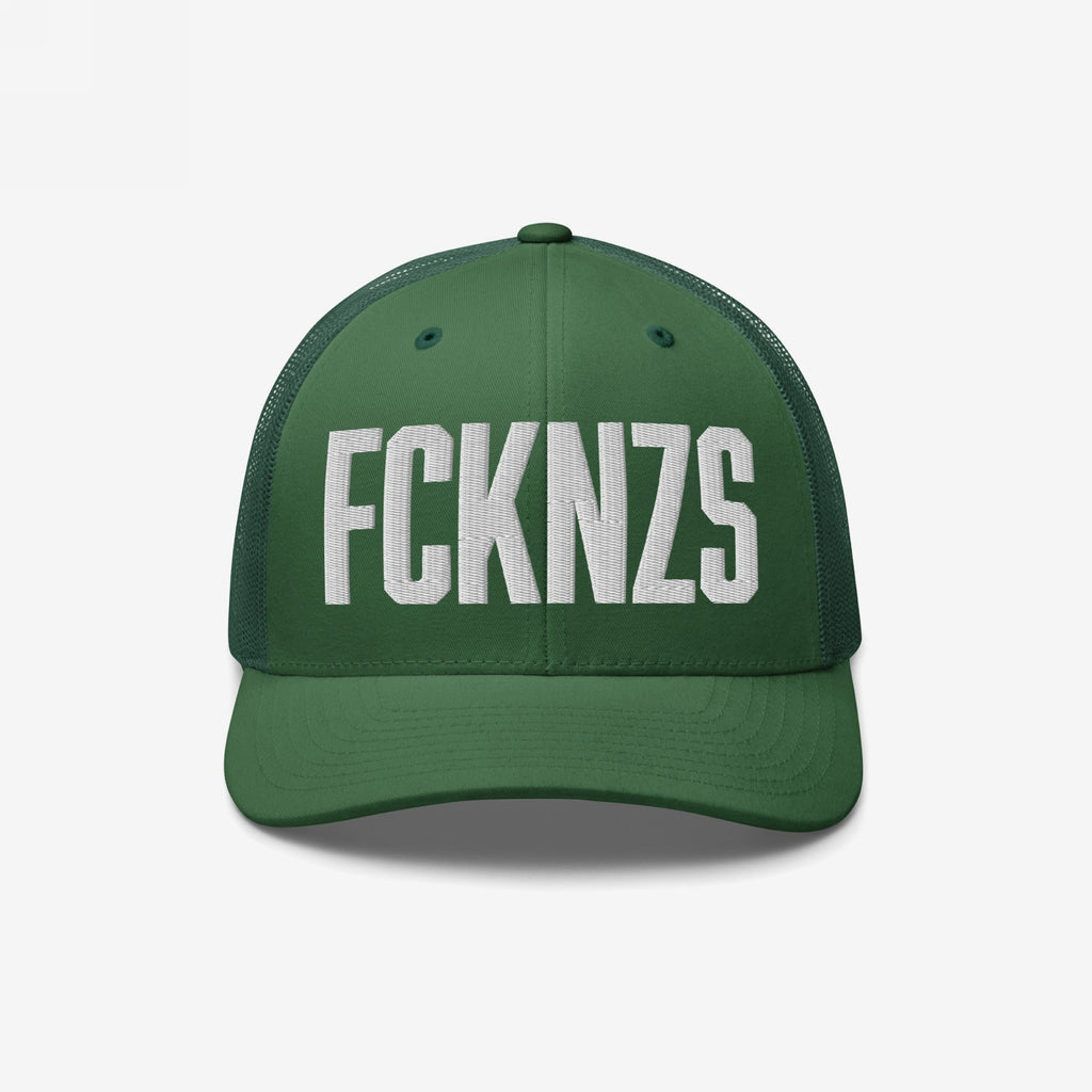 Dark-green FCKNZS Hat featuring white block-letter embroidery, curved brim, and mesh back panels. This trucker cap embodies an anti-fascist message, perfect for marches and everyday expression against hate.