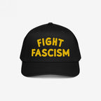 Fight Fascism Hat featuring bold yellow FIGHT FASCISM embroidery on a black baseball cap, designed for anti-fascist advocacy and visibility at marches, events, and everyday outings.