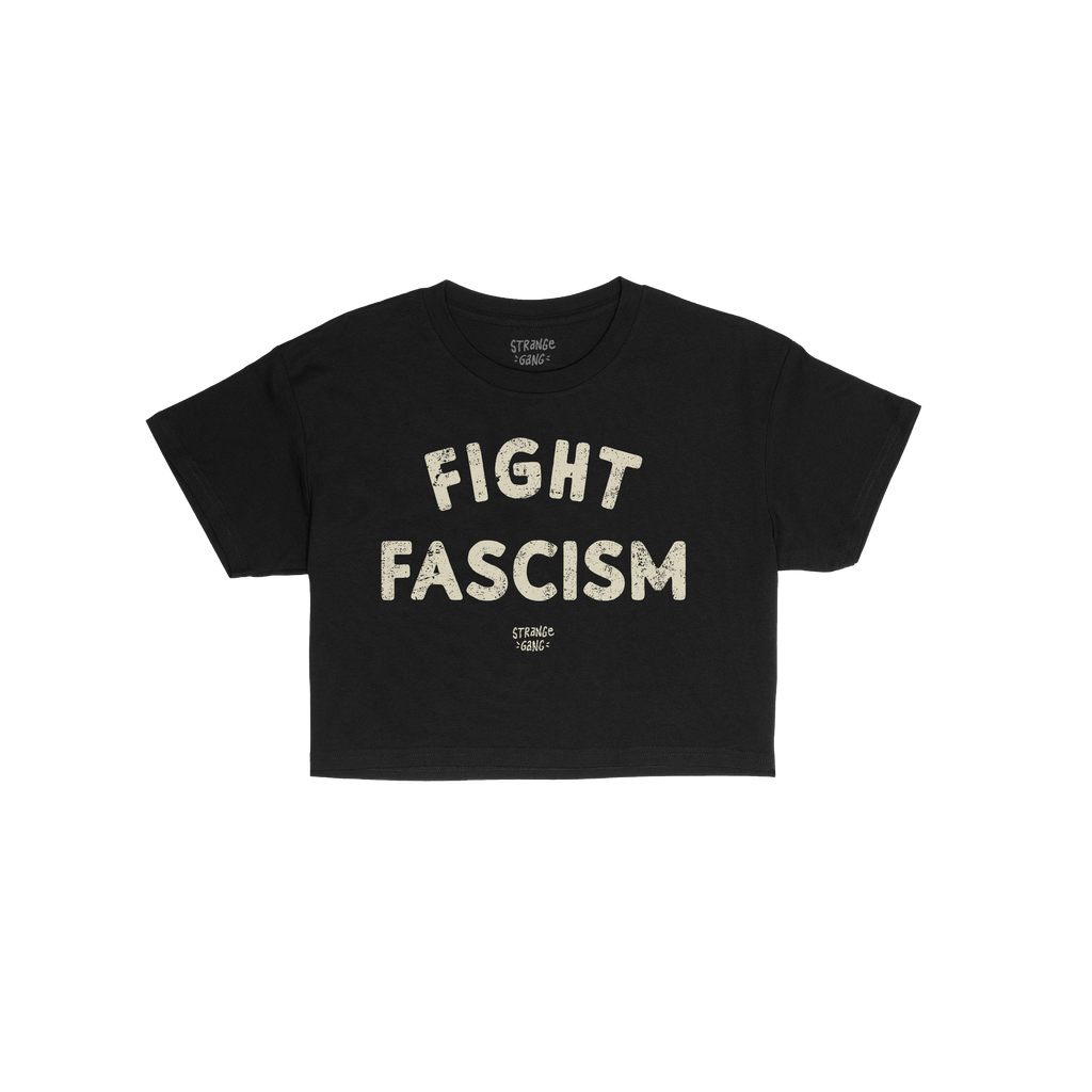 Black Fight Fascism Women's Baby Tee with large cream slogan and small brand text below, embodying anti-fascist spirit. Ideal