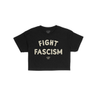 Black Fight Fascism Women's Baby Tee with large cream slogan and small brand text below, embodying anti-fascist spirit. Ideal
